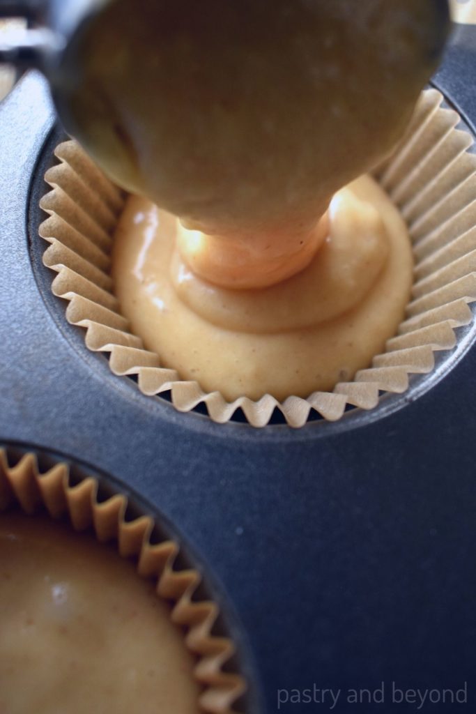 Placing batter into the muffin tin with a cookie scoop.