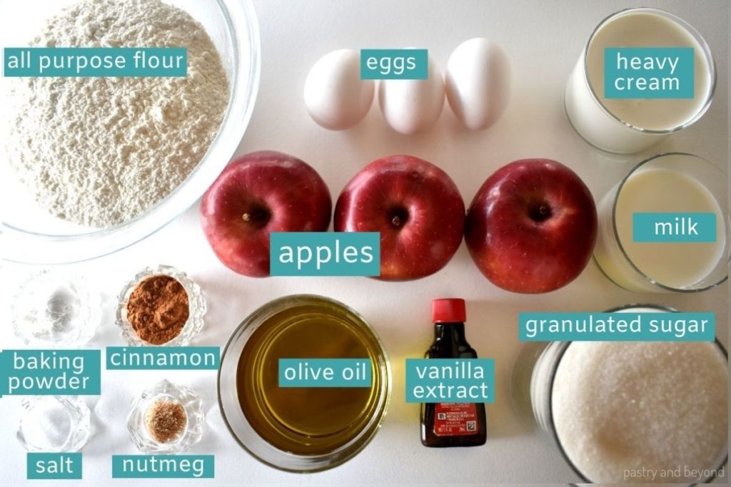 Ingredients of apple cinnamon bundt cake on a white surface.