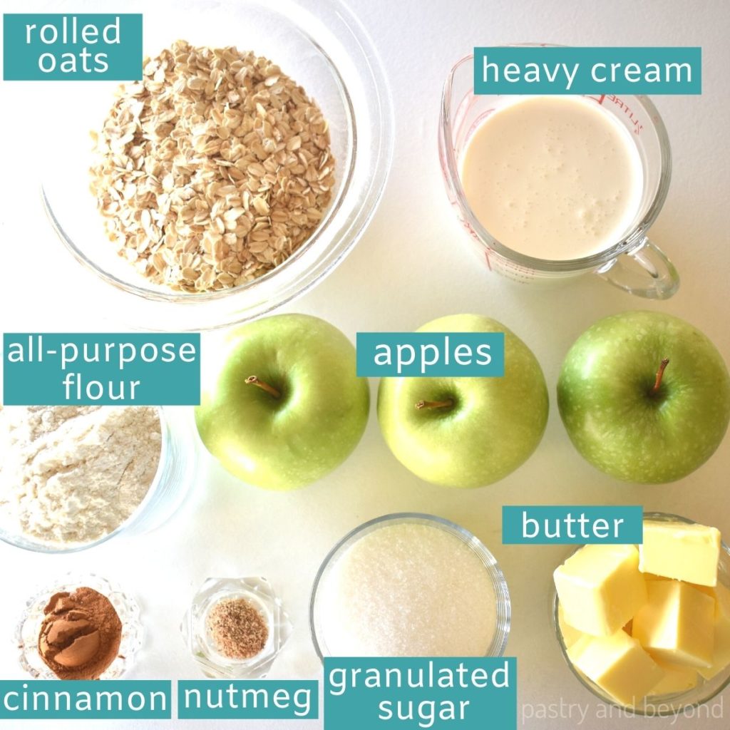 Ingredients of apple oatmeal bars on a white surface.