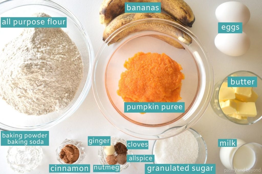 Ingredients for pumpkin banana muffins on a white surface.