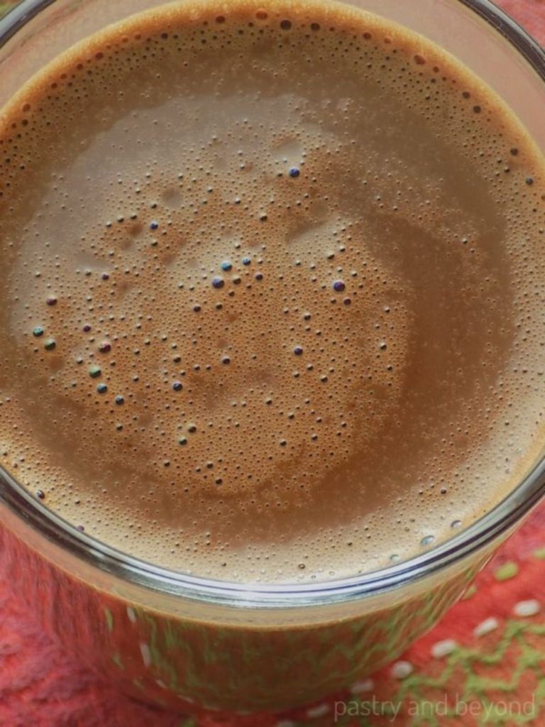 Overhead view of homemade hot chocolate in a glass.