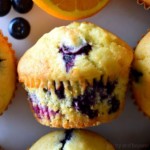 A close up orange blueberry muffin.