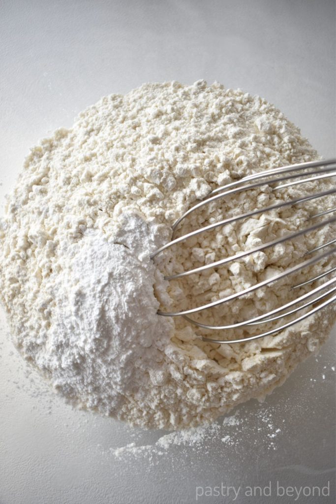 Flour, baking powder in a large bowl with a whisk.