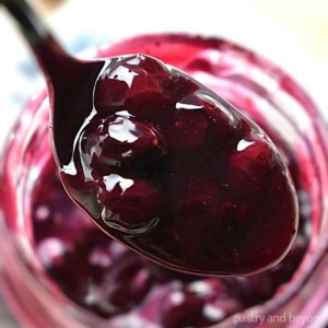 Blueberry sauce on a spoon.