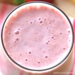 Overhead view of strawberry banana smoothie that is in a large glass.