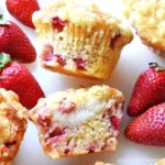 Strawberry cream cheese muffins on a white surface.