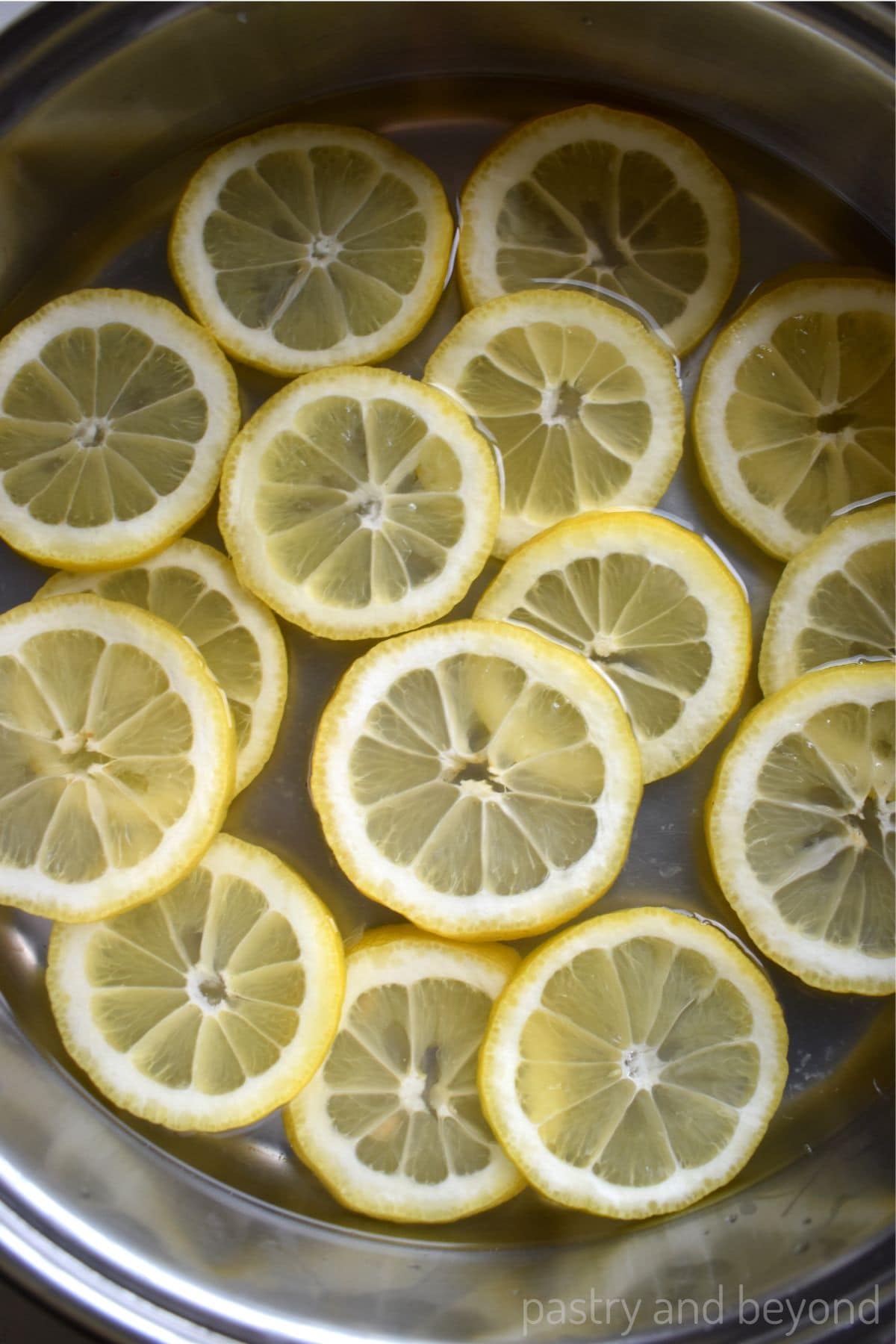 Lemon slices in a pan with water.