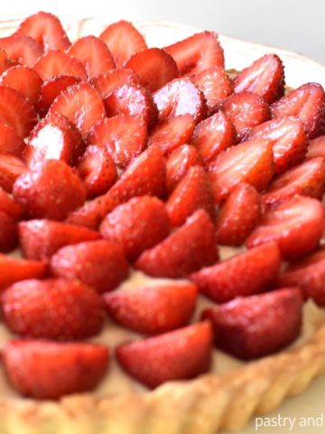 Strawberry custard tart on a plate.