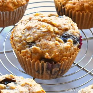 Banana blueberry oatmeal muffins on a wire rack.
