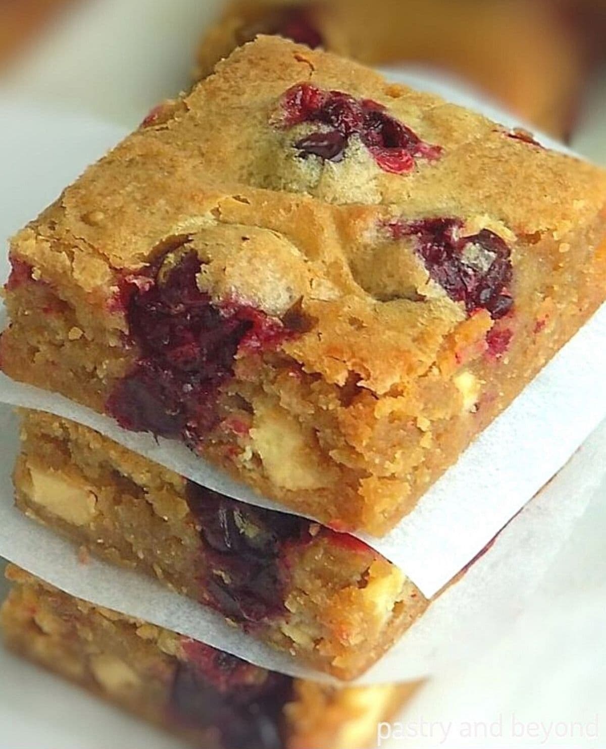 Side view of stacked cranberry blondies.