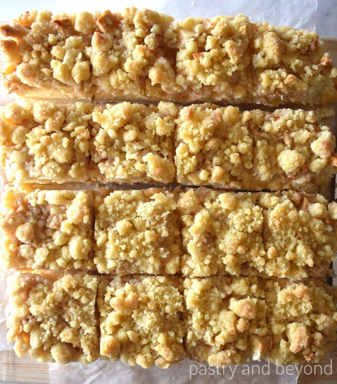 Apple cheesecake bars that are cut into sixteen pieces.