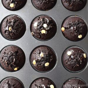 Triple chocolate muffins in a muffin pan.