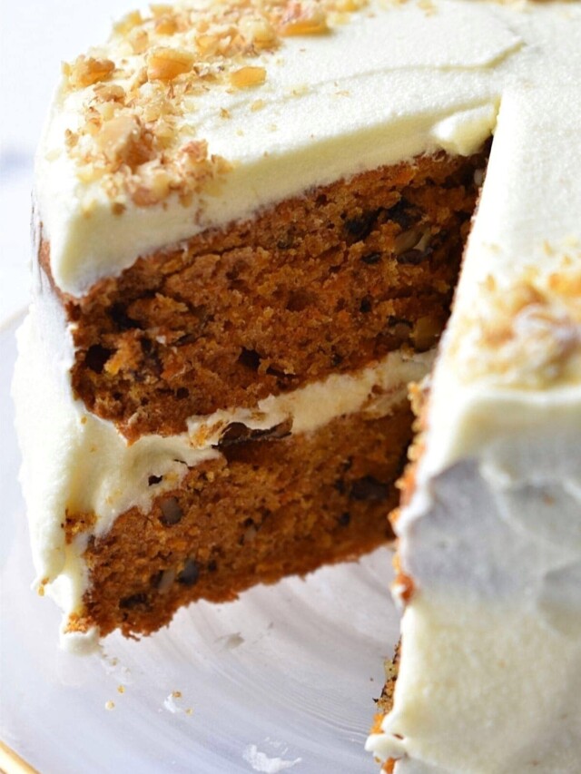 Mini carrot cake with a slice taken from it.