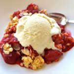 Strawberry crumble with vanilla bean ice cream on top.