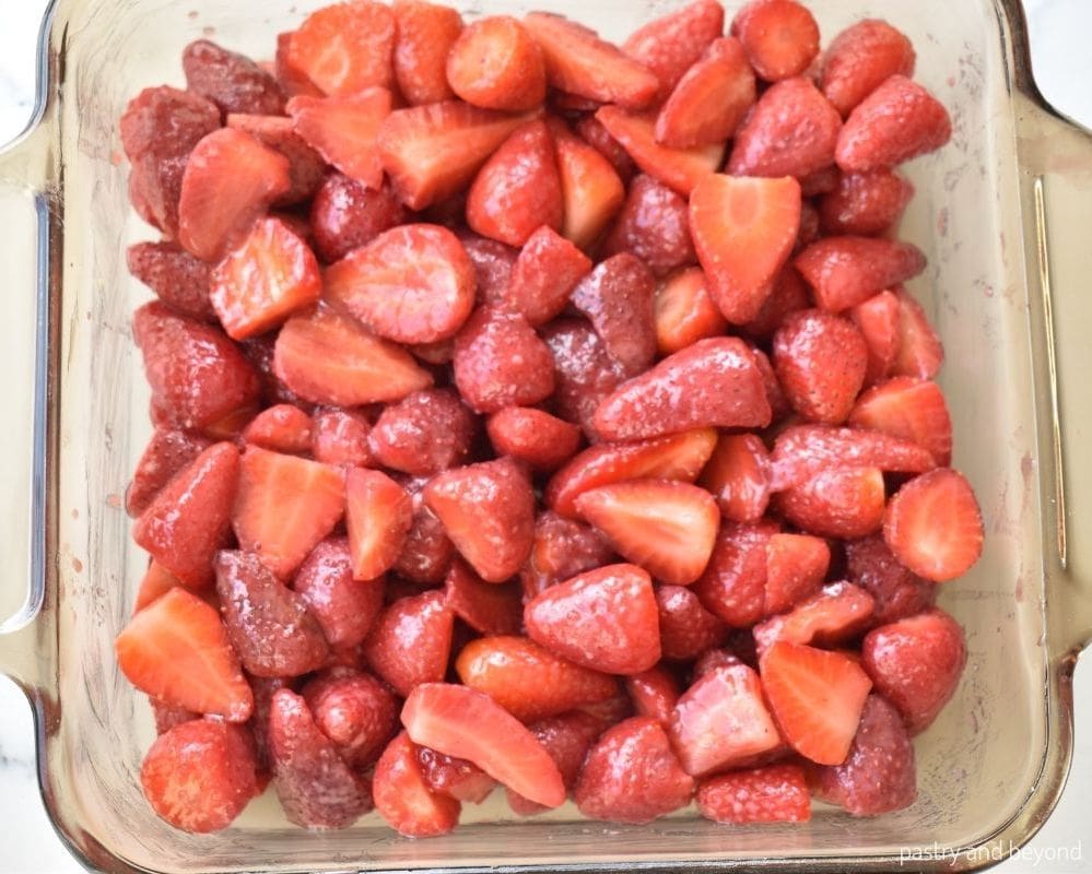 Strawberries that are placed in a baking dish.
