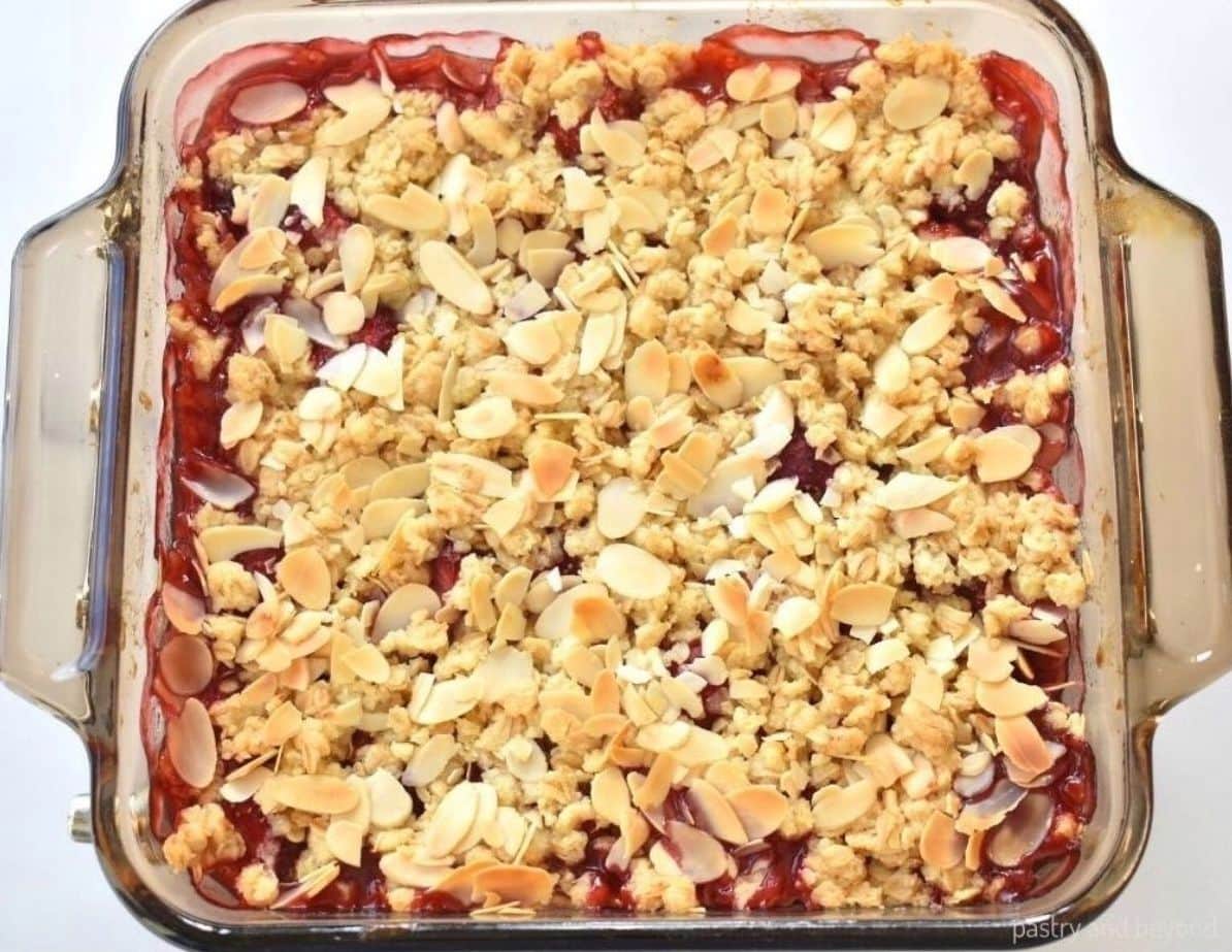 Strawberry crumble after baked in a square baking dish.