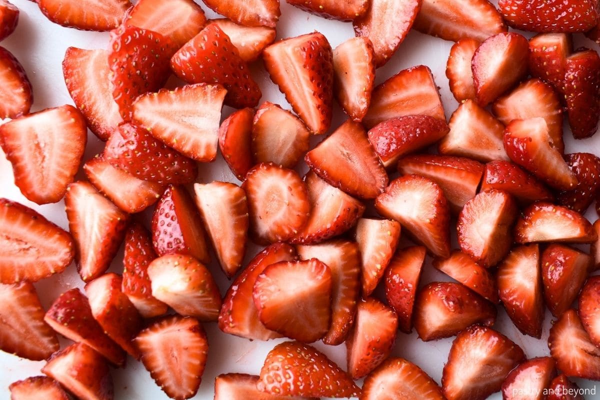 Strawberries that are cut in half and three pieces.