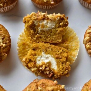 Carrot cake muffin with cream cheese filling in the middle.