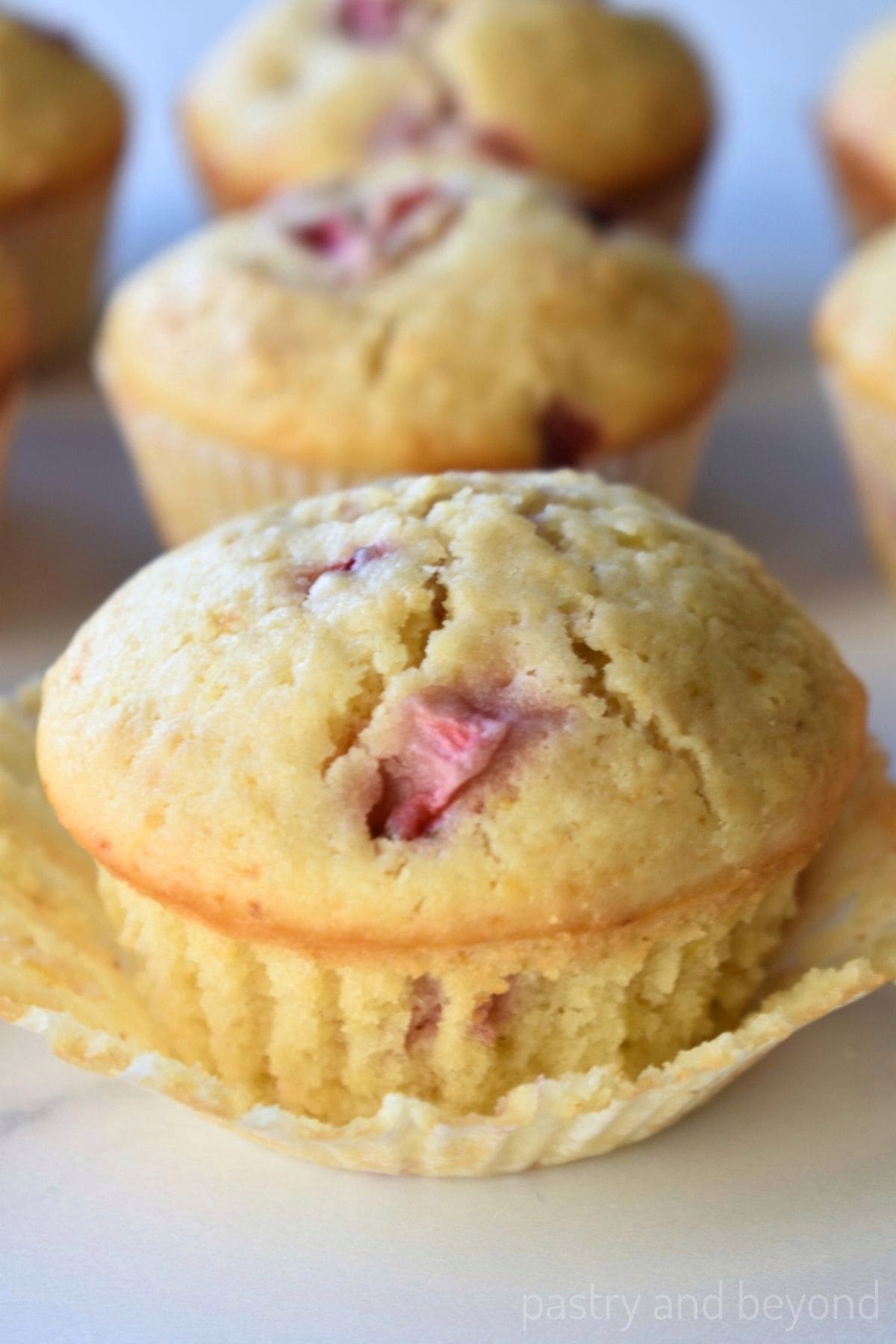 Strawberry lemon muffins in paper liners.